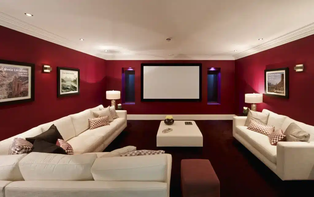 entertainment center with red walls and white couches