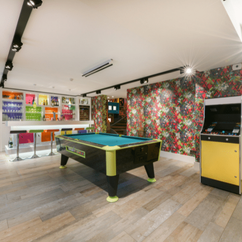 Basement bar with arcade games and pool table